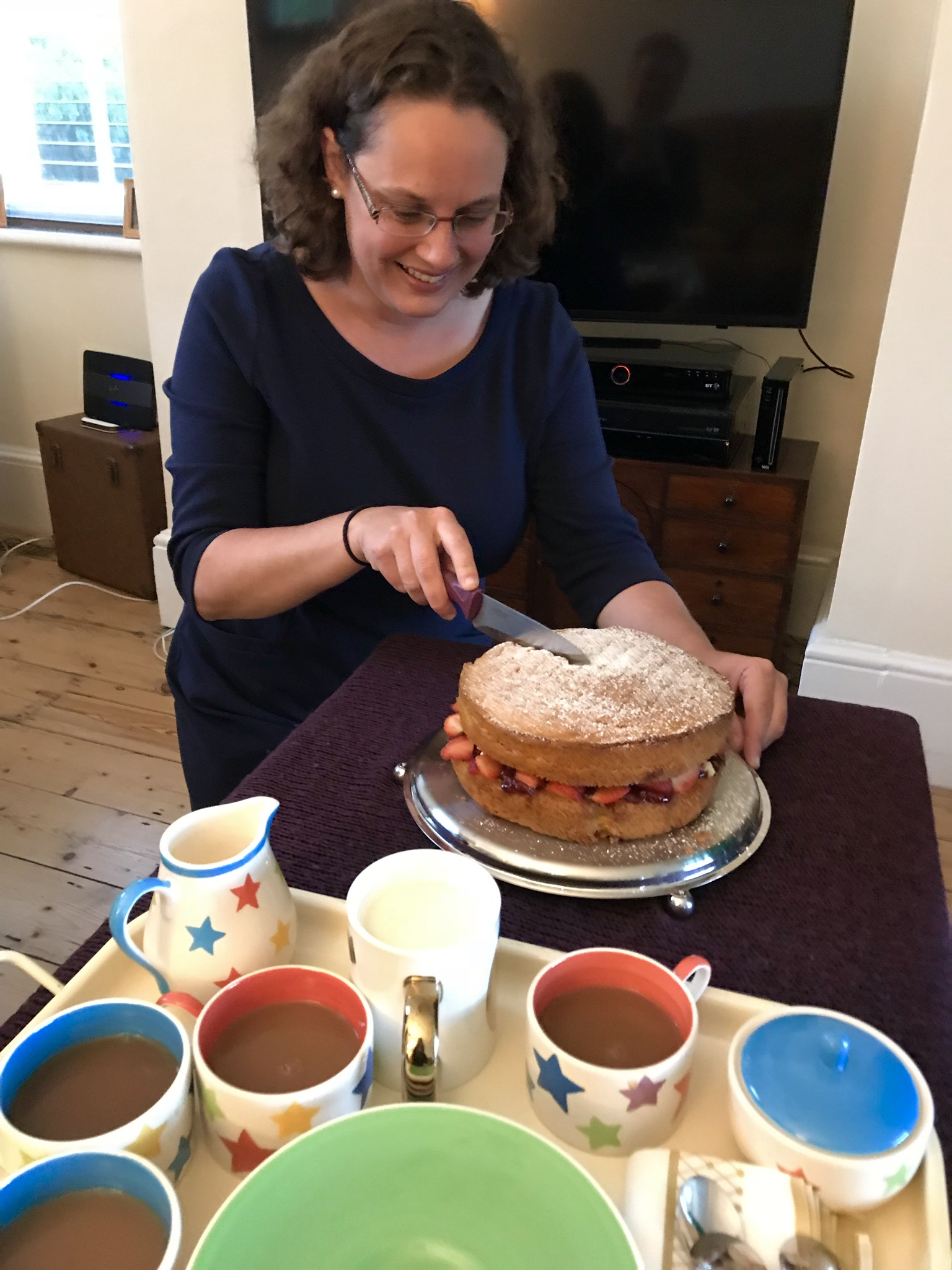 Emily Shaw serves cake and tea
